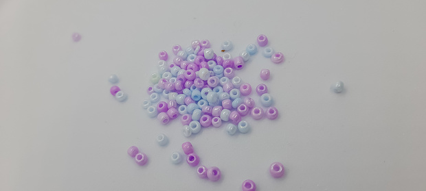 close up colored beads heap isolated on white. Kid's DIY Craft. Children's Necklace Beads. Manik-manik