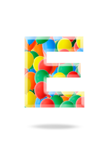 Close-up of three-dimensional multi colored balloon alphabet letter E on white background.