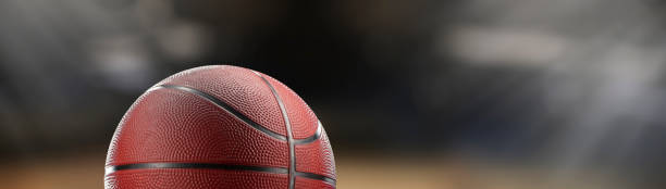 istock basketball ball in a stadium close up - copyspace 2095337126