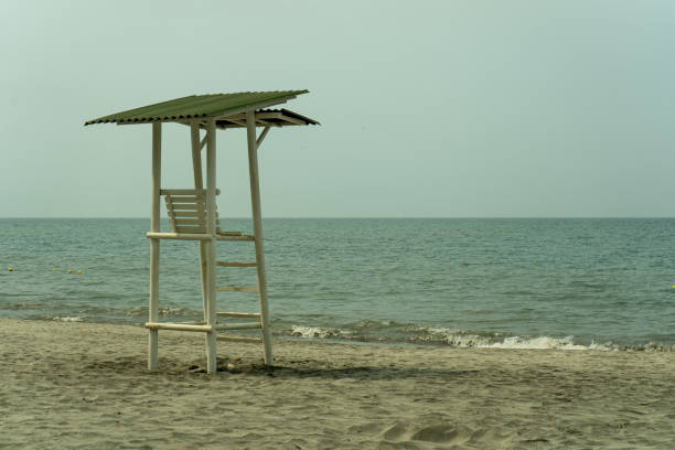 Lifeguard stand with a sunset background over the Caribbean Sea