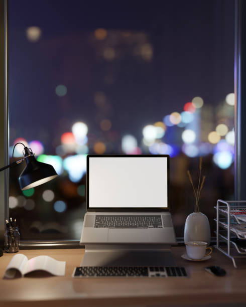 istock A laptop computer mockup on a computer stand on a desk against the window with a night city view. 2095462063