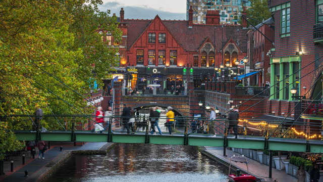 4K Footage time lapse of Birmingham cityscape canal side street with crowd people and tourist in Birmingham Brindley Place at sunset time, England, UK, Travel and Destination Tourist concept.