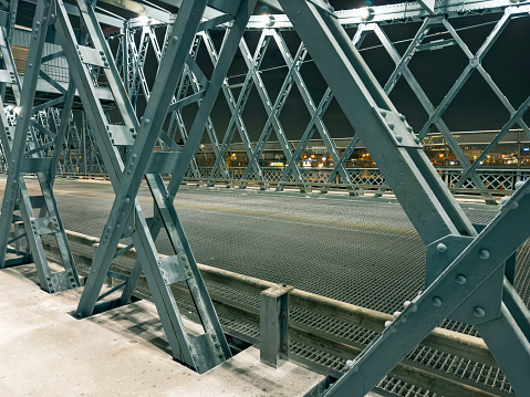 Close up metal suspension bridge detail at night