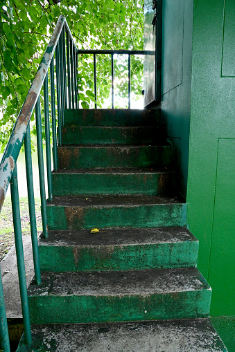 Closeup of The Green cement stairs with green steel handrails for going upstairs at Thailand.