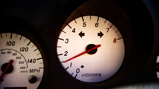 a view of gauges in an old sports car