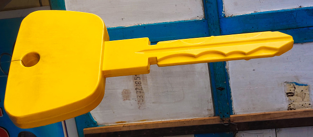A yellow key toy with a large size