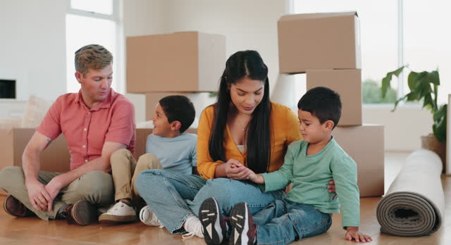 Happy, moving and box with family in new house for property, mortgage and investment. Relax, sale and future with parents and children in living room of home for real estate, growth and purchase