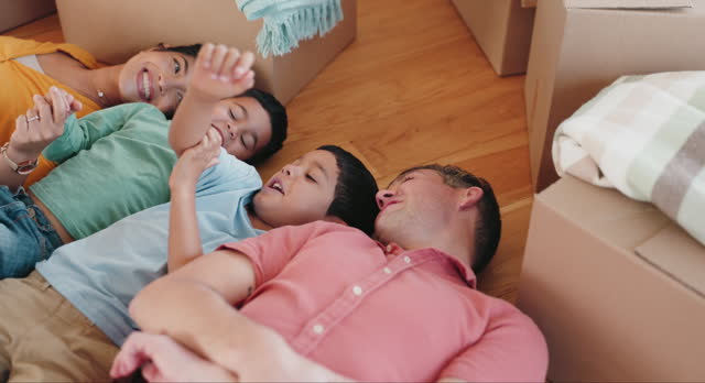 Floor, moving and box with family in new house for property, mortgage and investment from above. Relax, sale and future with parents and children of home for real estate, growth and purchase