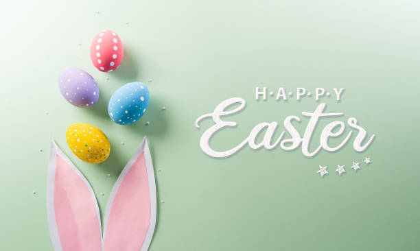 istock Easter party concept. Top view of easter bunny ears and colorful eggs on pastel background with copyspace for the text. 2095576973