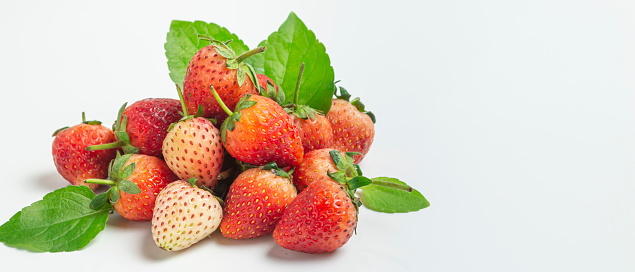 Bright red strawberries, sweet and delicious, on a white background.