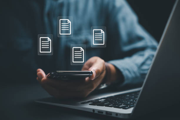 istock Business professional taking charge of his files and documents through a mobile document management system 2095582225