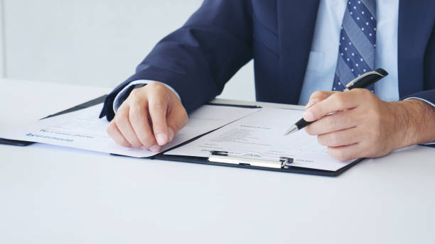 istock Businessman hands note meeting document in conference room. man Hands writing planning notebook. Close up male hand holding pencil write on diary sketchbook at office desk. Business Planning Concept 2095643542