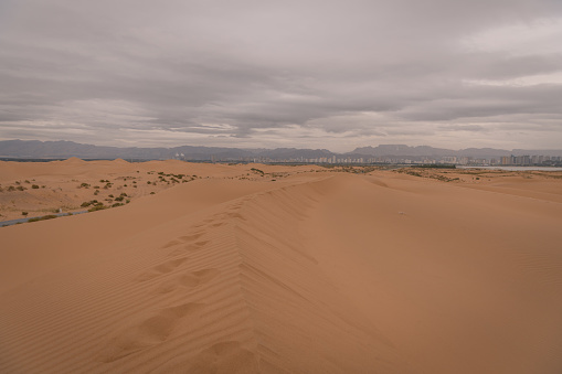 View on Wuhai City, Inner Mongolia, China from the desert. Vertical background, copy space for text