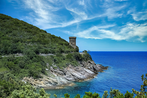 Corsica, the Losse tower, ancient genoese fortress on the coast, seascape in spring