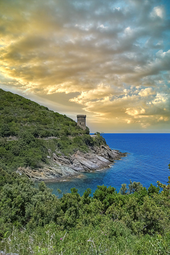 Corsica, the Losse tower, ancient genoese fortress on the coast, seascape in spring