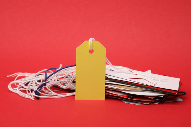 Blank price tag on red background. Sale concept
