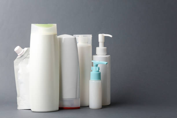 istock Different shampoo and other cosmetic product bottles on pink background 2095713290