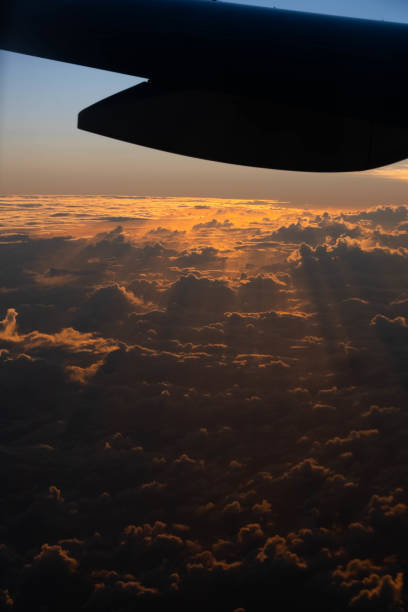 unique clouds and sunrise beyond the airplane window