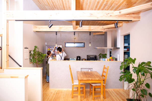 Newly built kitchen, young Japanese couple, looking for something in the refrigerator