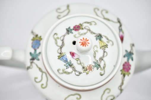 small porcelain teapot with cheerful flower pattern