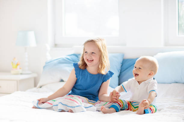 istock Kids playing on parents bed 2095740538