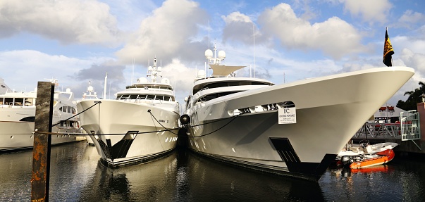 West Palm Beach, United States – October 12, 2018: Several big white boats docked at a marina on the water