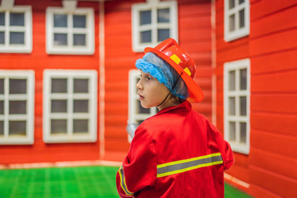 istock Children play firefighters, extinguish a toy fire 2095793112