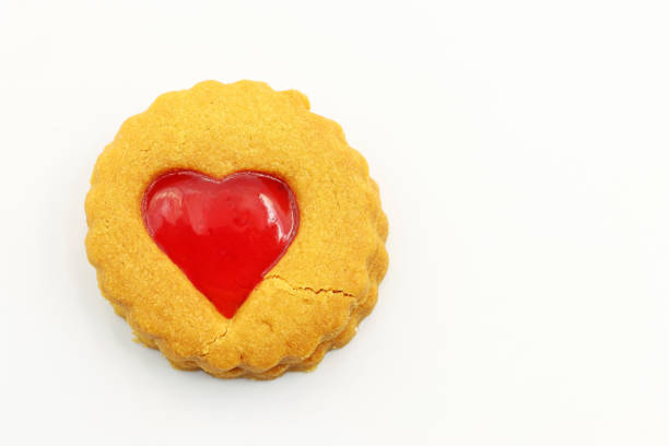 Handmade heart-shaped cookie with red, pink and white colors.