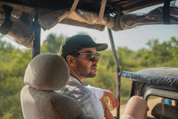 istock Young man in jeep on safari 2095848634