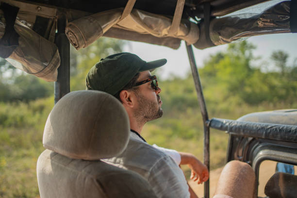 istock Young man in jeep on safari 2095848636