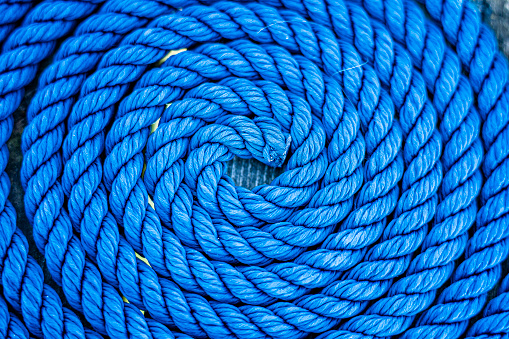 Top view close-up of a blue rolled-up ship's rope, 1:1
