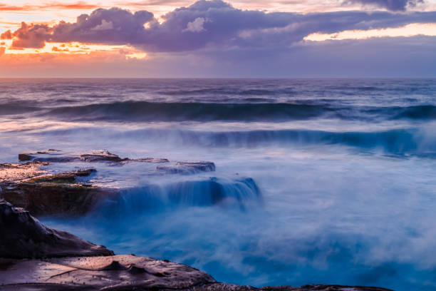 istock Sunrise, sea, waves, clouds and tessellated rock platform 2095869997