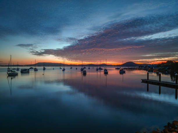 istock Sunrise over the water with boats and reflections 2095870507