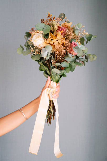 istock Bouquet of flowers held by hand 2095881532
