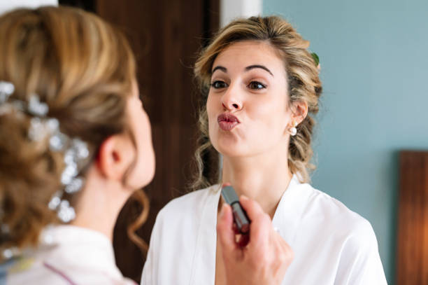 istock Beautiful blonde haired woman dressed in white on her wedding day before getting married, her mother helps her get dressed. 2095882061