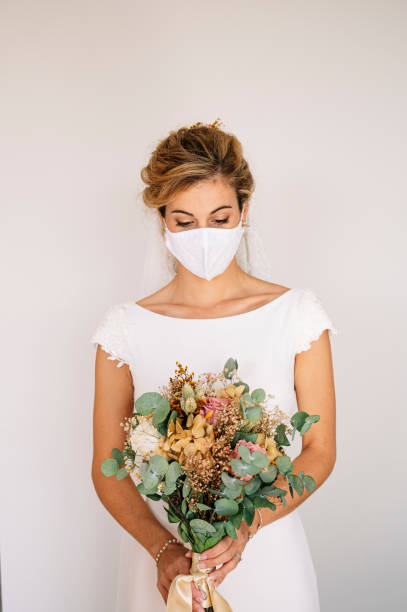 istock Bride wearing mask at wedding during COVID pandemic 2095883142
