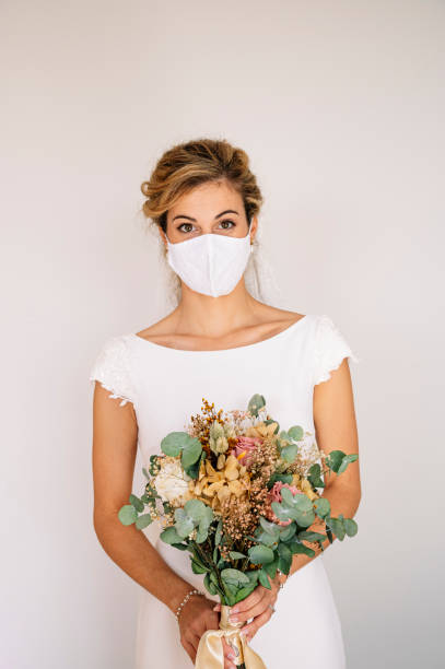 istock Bride wearing mask at wedding during COVID pandemic 2095883144