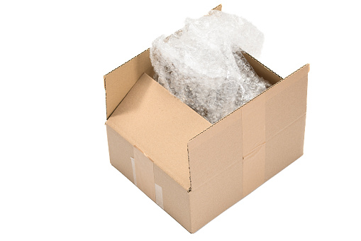 An open cardboard package on a white background, with bubble wrap inside to protect the shipment