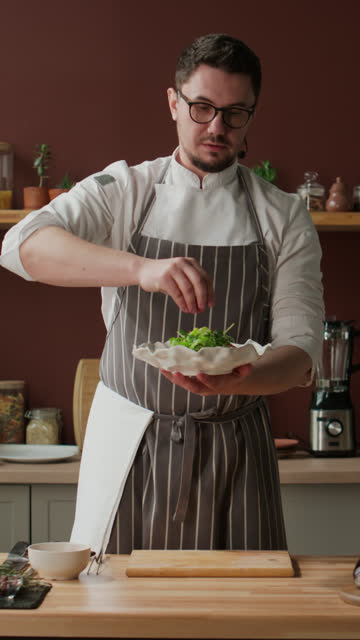 Vertical of Chef Making Salad while Recording Cooking Show