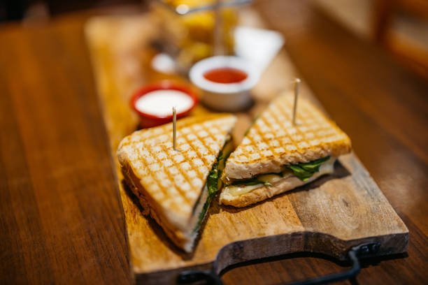Club sandwich and dipping sauces on the table in the pub.