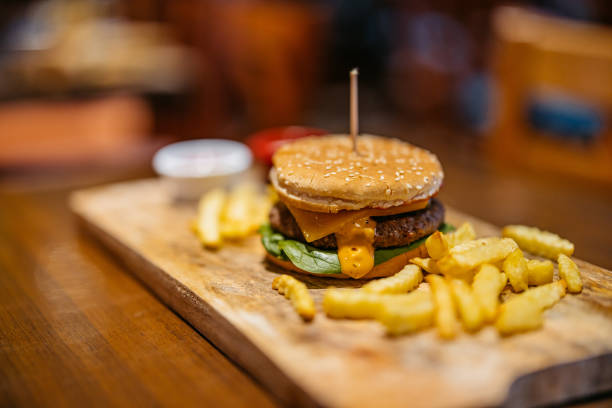 Cheeseburger with fries on the table in the pub.