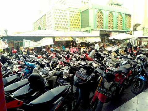 Kauman, Sidoarjo city, East Java, Indonesia, 03-17-2024 :
Parking zone for motor cycle in street market.
It is a public place and free zone for all commercial activities.