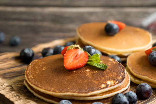 istock pancakes with strawberries and blueberries on the table 2095964040