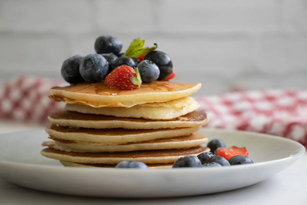 istock pancakes with strawberries and blueberries on the table 2095967158