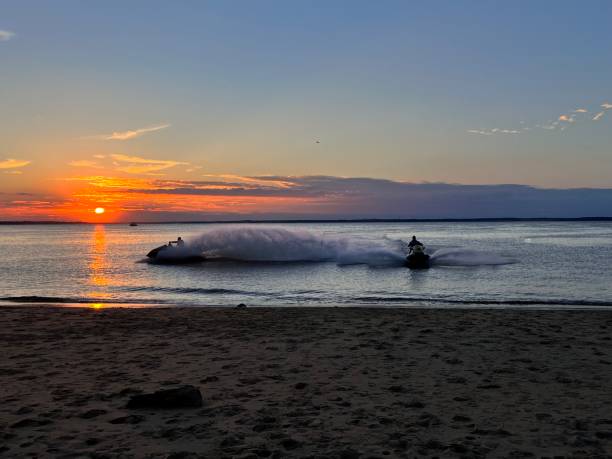 istock Group riding a jet ski at sunset on a beach 2095976174