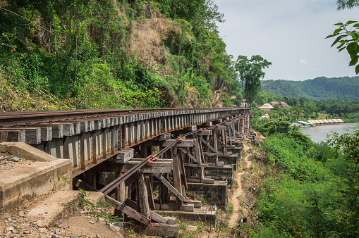 Wooden railway bridge along the River Kwai Beautiful scenery of Kanchanaburi Province