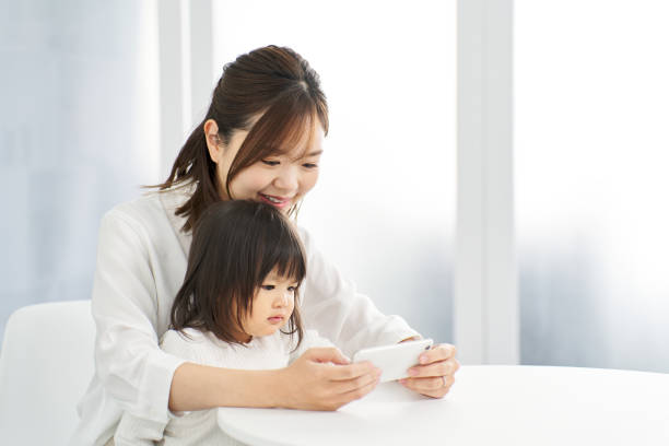 istock Girl looking at smartphone with mom 2095989275