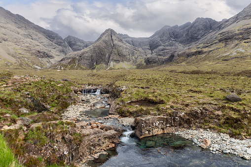 Gentle streams thread through the rocky landscape at the Fairy Pools, with the majestic Cuillin ridges looming in the background
