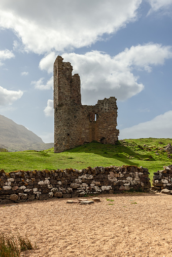 Amidst Scotland's rugged terrain, the remnants of Ardvreck Castle rise, a testament to the country's medieval past. Its weathered walls and the stark beauty of its surroundings create a captivating scene
