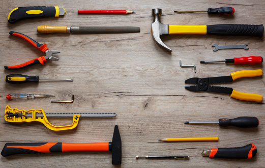 A set of hand tools on a wooden background. The concept of repair work. Copy space